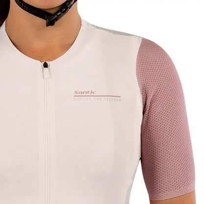 Santic kortermet sykkeltrøye for dame i hvit og støvrosa med mesh-ermer og logo på brystet.