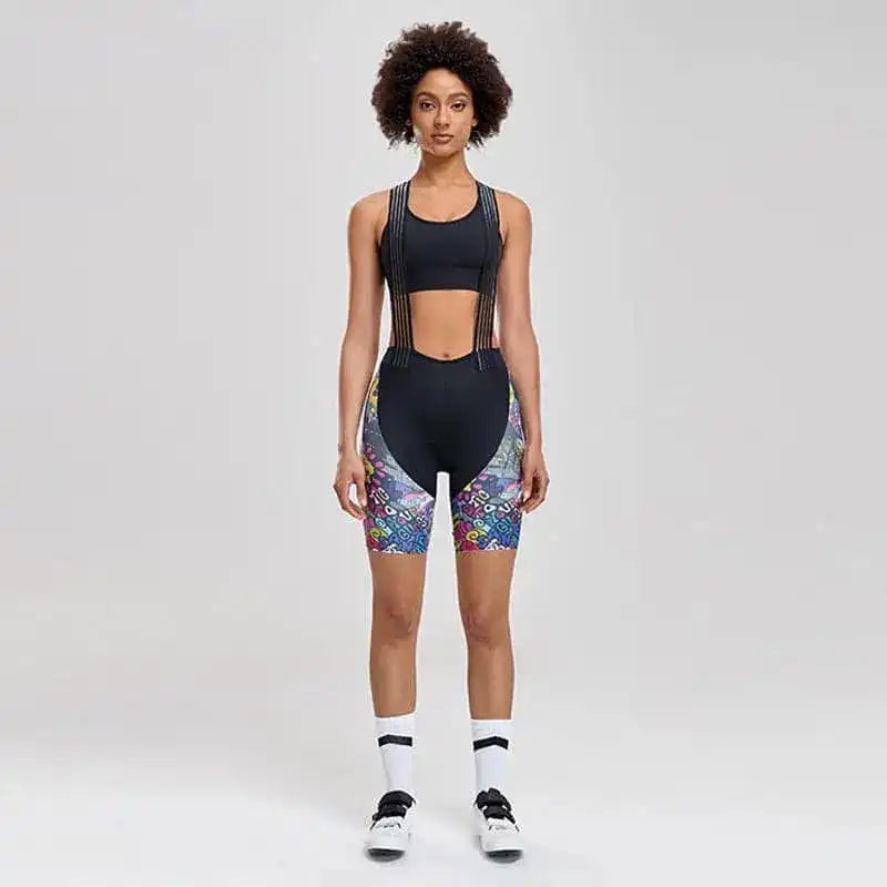 Svart bib-sykkelshorts til dame med fargerike mønstrede sidepaneler og svart sportstopp.